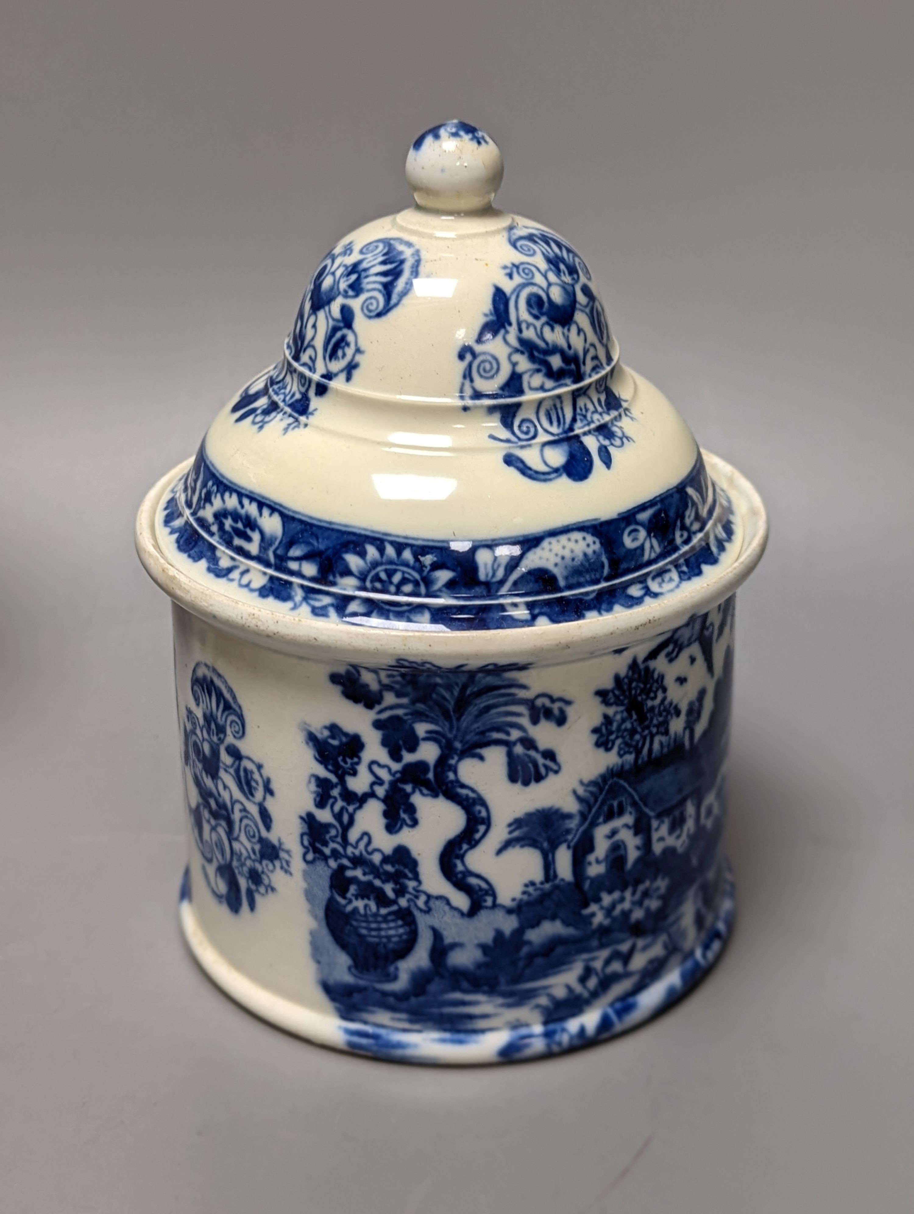 Four items of early 19th century blue and white pearlware pottery, an 18th century Delft blue and white vase and a 19th century toothbrush holder, Delft vase 22 cms high.